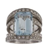 An aquamarine and diamond ring, the rectangular step cut aquamarine in a four claw setting, with