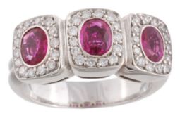 A pink sapphire and diamond ring, the three oval shaped pink sapphires with a surround of