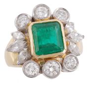 An emerald and diamond cluster ring, the rectangular step cut emerald in a collet setting within a s