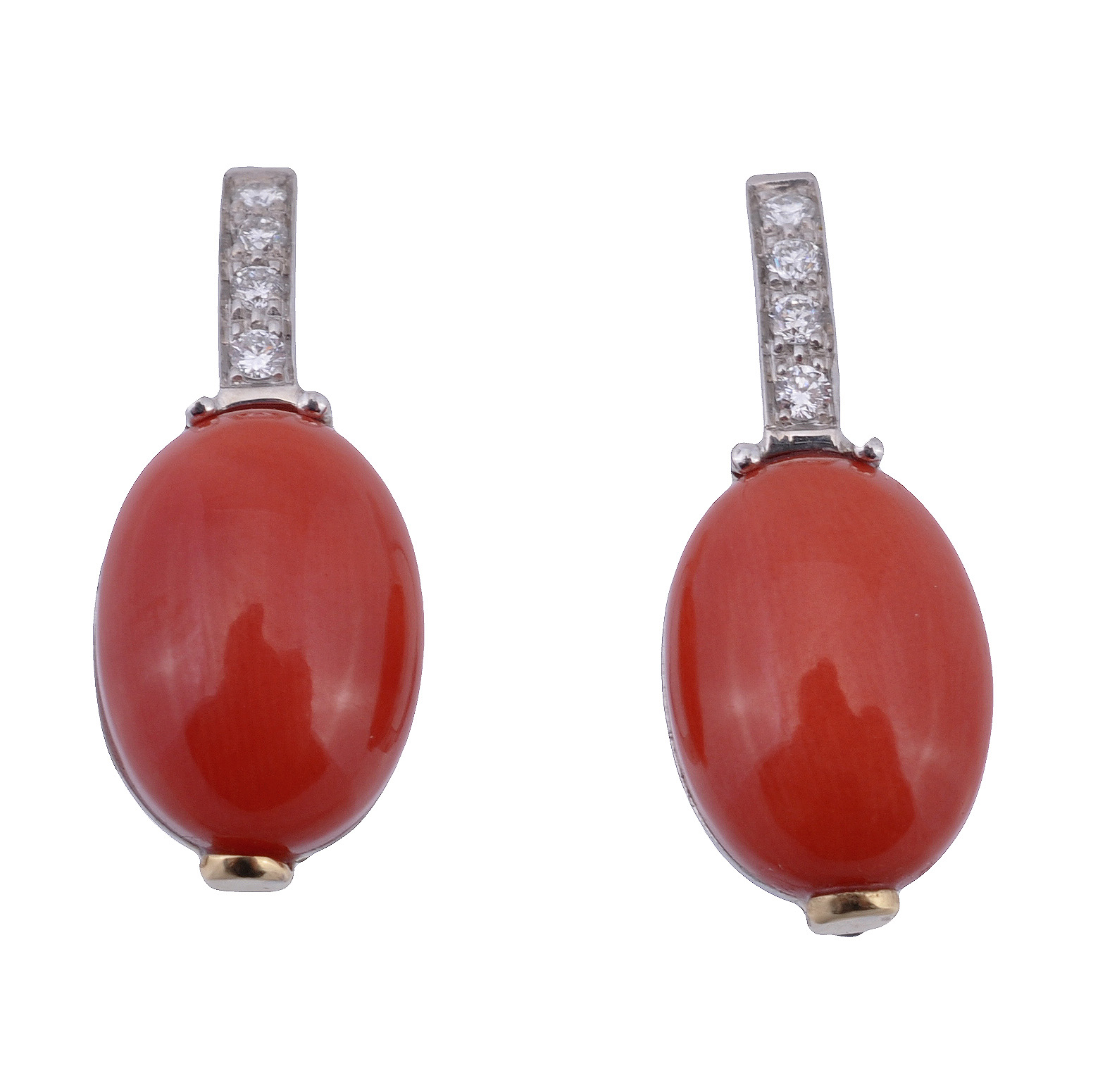 A pair of coral and diamond earrings, the oval cabochon coral panels surmounted with a vertical