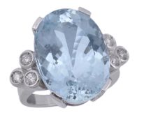 An aquamarine and diamond ring, the oval fancy cut aquamarine in a four claw setting, to the