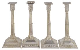 A set of four electro-plated cluster column candlesticks by Mappin Bros  A set of four electro-