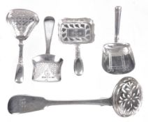 A group of George III to William IV four silver caddy spoons and a sugar...  A group of George III