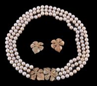 A three strand cultured pearl necklace with vine leaf clasp, composed of one hundred and forty six