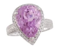 A kunzite and diamond ring, the pear shaped kunzite, estimated to weigh  8.31 carats, in a claw