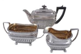A matched late George III silver oblong three piece tea service, the tea pot by T. & J. Guest &