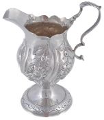 A George III silver baluster cream jug by Robert Hennell I, London 1773, with a leaf-capped double