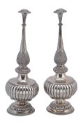 A pair of silver rosewater sprinklers, unmarked, probably Indian, 19th century, the diced dome tops