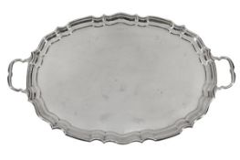 A silver twin handled shaped oval tray by Alexander Clark & Co. Ltd., Birmingham 1918, with a