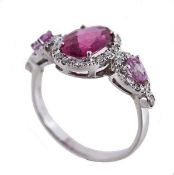 A pink tourmaline, pink sapphire and diamond ring, the oval fancy cut pink tourmaline within a