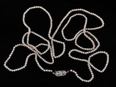 A pearl necklace with diamond set clasp, the uniform pearls measuring approximately 4mm, to a gold