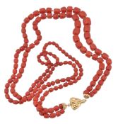 A two strand coral bead necklace, the graduated faceted coral beads (corallium rubrum), to reeded
