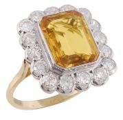 A yellow sapphire and diamond cluster ring, the central rectangular step cut yellow sapphire collet