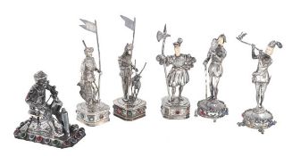 Six German silver coloured and coloured glass figures, circa 1910, comprising: three standing