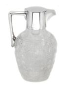 A late Victorian silver mounted cut glass claret jug by Heath and Middleton, London 1898, after the