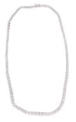 A diamond riviere necklace, set along the length with one hundred and three graduated brilliant cut