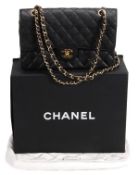 Chanel, a black quilted caviar leather handbag, with flap front and Chanel gilt metal Mademoiselle