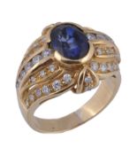 A sapphire and diamond dress ring, the central oval cut sapphire within a shaped surround set with