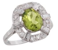 A peridot and diamond ring, the central oval fancy cut peridot in a claw setting, within a surround