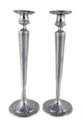A pair of American Arts and Crafts hammered silver tall candlesticks by Petterson Studio, Chicago,