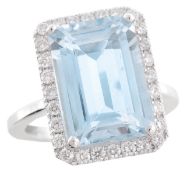 An aquamarine and diamond cluster ring, the central rectangular step cut aquamarine, estimated to