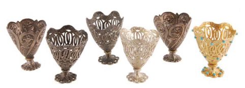 Six Ottoman silver coffee cup holders (zarfs), Tughra and sah marks, circa 1900, one gilt and