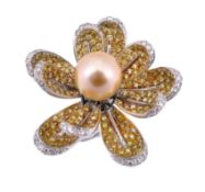 A flowerhead cluster dress ring, the flowerhead centred with a yellow cultured pearl, within a