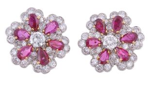 A pair of ruby and diamond ear clips, the flower head cluster with a central brilliant cut diamond