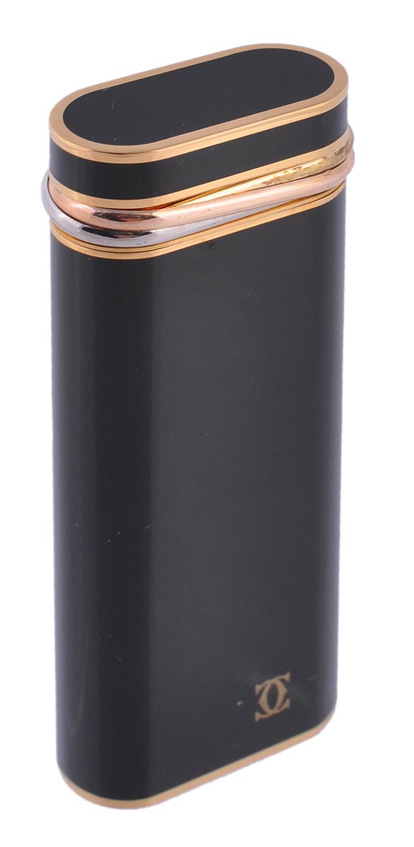 Cartier, a black lacquer lighter,  no E66281, the oblong shaped lighter with trinity ring detail,