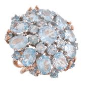 An aquamarine cluster dress ring by Fabrizio Caviglia, the target cluster set with round and oval