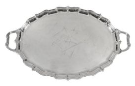 A silver shaped oval twin handled tray by Mappin Webb, Sheffield 1929, the raised border with a