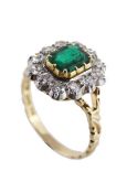 A Swedish emerald and diamond cluster ring, the step cut emerald  with canted corners, within a