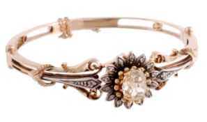 A diamond sunflower bangle, the sunflower head set with a central oval cut yellow diamond weighing