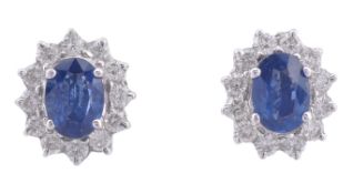 A pair of sapphire and diamond cluster ear studs and matching pendant, the ear studs with oval cut