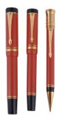 Parker Duofold orange Centennial fountain pen and pencil set, the pen with gold colour bands to the