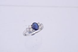 A sapphire and diamond seven stone ring, the central oval cut sapphire between two trios of