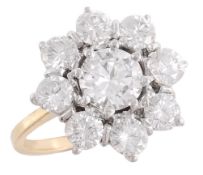 A diamond flower head cluster ring, the central brilliant cut diamond within a surround of eight