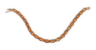 A citrine and diamond bracelet, the bracelet with oval cut citrines in four claw settings,