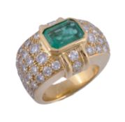 An emerald and diamond dress ring, the step cut emerald with canted corners in a collet setting