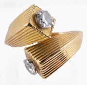 An 18 carat gold double ended diamond ring by Kutchinsky, the two brilliant cut diamonds,