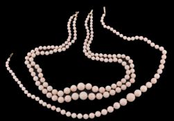 A two row coral bead necklace, the graduated coral beads measuring 4mm to 13mm diameter, with a