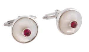 A pair of ruby and mother of pearl cufflinks, the circular faceted mother of pearl panels with a