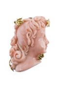 A coral brooch/pendant and ear clips, the brooch/pendant composed of a carved coral female profile,