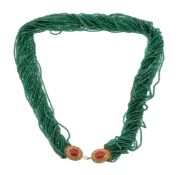 An emerald and aventurine quartz multi strand necklace, the rows of faceted emeralds and polished