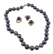 A suite of black South Sea cultured pearl jewellery, comprising a strand of thirty three 11mm to