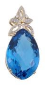 A blue topaz pendant, the fancy cut blue topaz in a four claw setting, to a brilliant cut diamond