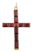 A garnet cross pendant, the Latin cross set throughout with rectangular step cut garnets in a