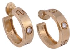 Cartier, Love, a pair of diamond ear hoops, the hoops set with a brilliant cut diamond and with
