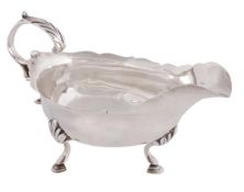 A George III silver oval cream boat by Hester Bateman, London 1783, with a leaf-capped flying