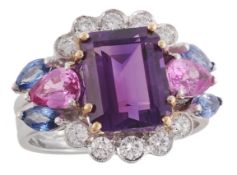 An amethyst and diamond ring, the central rectangular step cut amethyst claw set within a cluster
